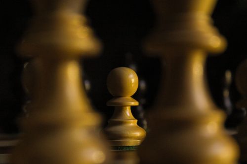 Free Focused view of a wooden chess pawn, highlighting strategy and challenge concept. Stock Photo