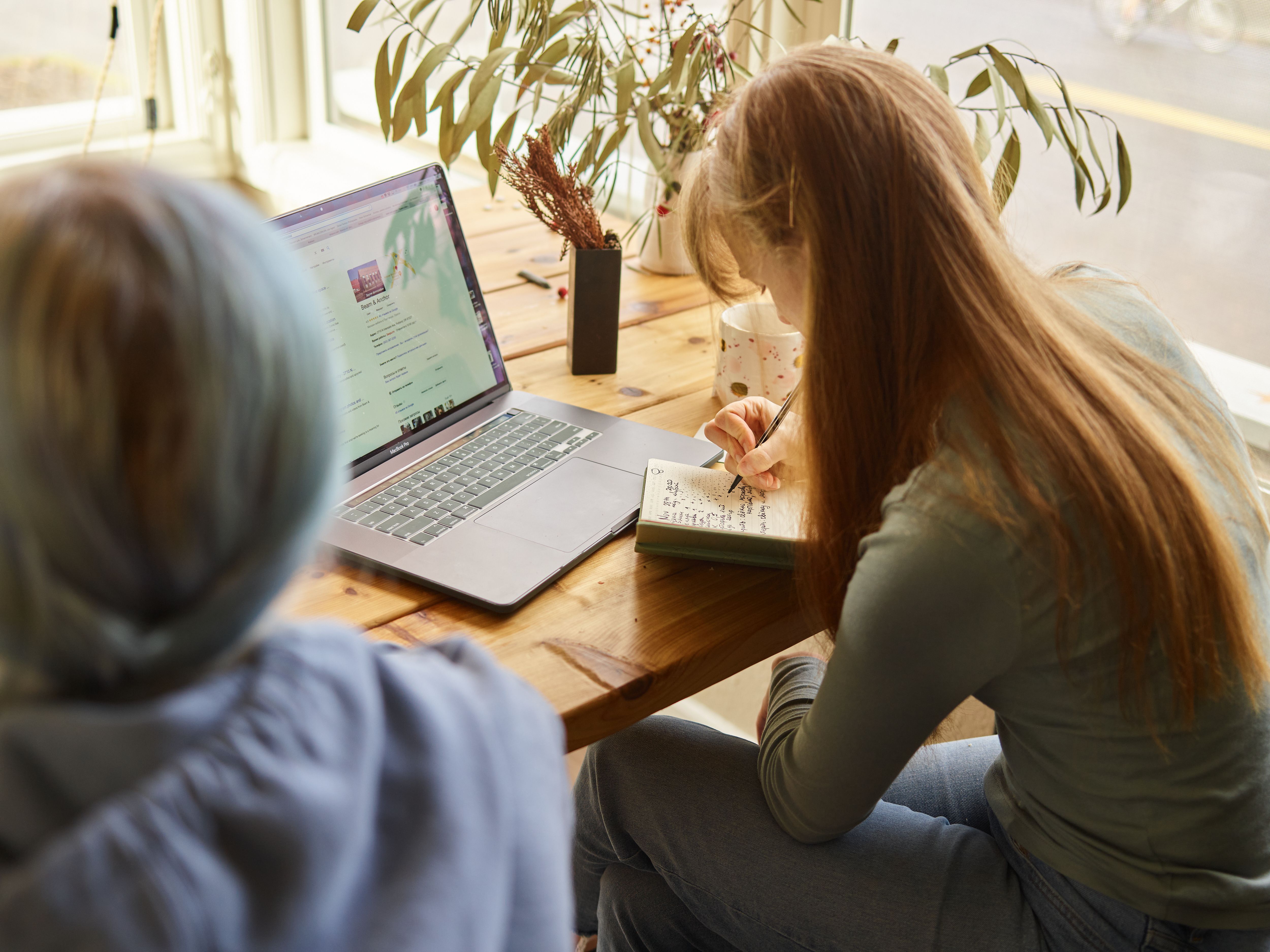 Woman researching coaches on her laptop - coaching and personal development