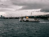 White and Black Ship on Sea Under Cloudy Sky