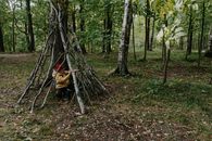 Woman in Brown Jacket Sitting on Brown Tree Log