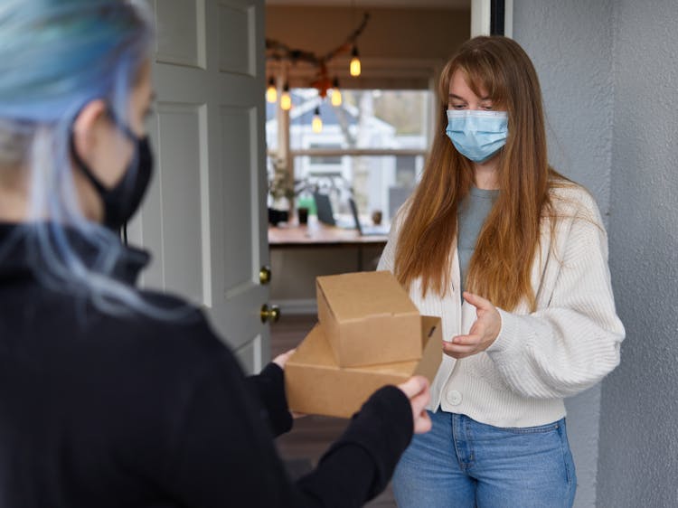 Woman Receiving Packages On The Doorway