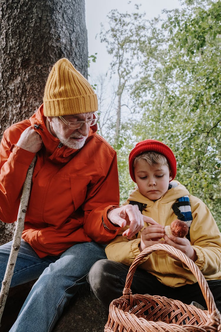 Grandfather And His Grandson Sitting Near A Tree