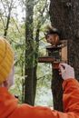 Person in Yellow Shirt Holding Brown Wooden Bird House