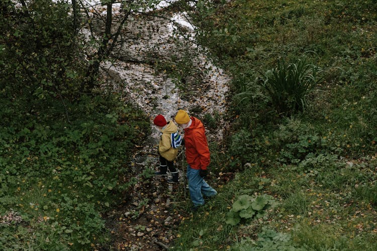 A Man And Kid Walking In The Forest 