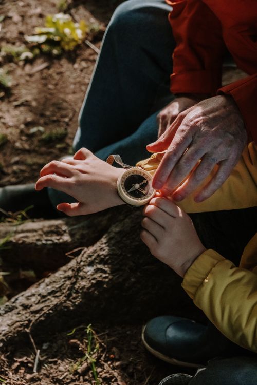Free Close-up of hands holding an antique compass outdoors, symbolizing direction and exploration. Stock Photo