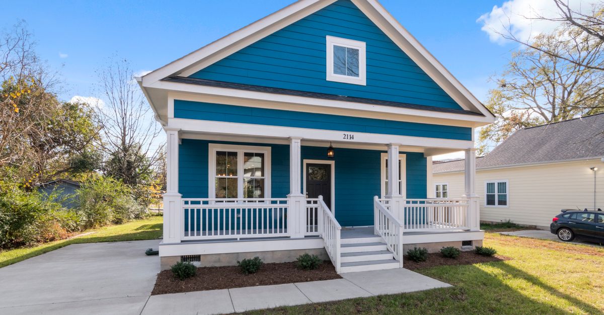 Exterior view of a blue suburban house with a welcoming front porch.