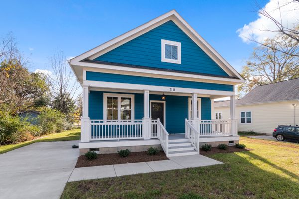 Blue suburban house with a white front porch