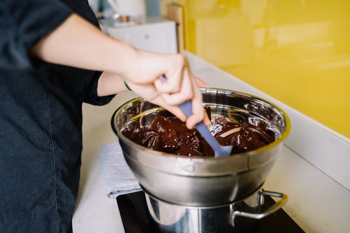 Melted chocolate being stirred in a steel bowl, photo by Anna Tarazevich on Pexels