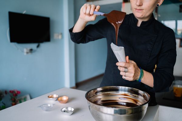Chocolatier checking tempered chocolate on a spatula, photo by Anna Tarazevich on Pexels