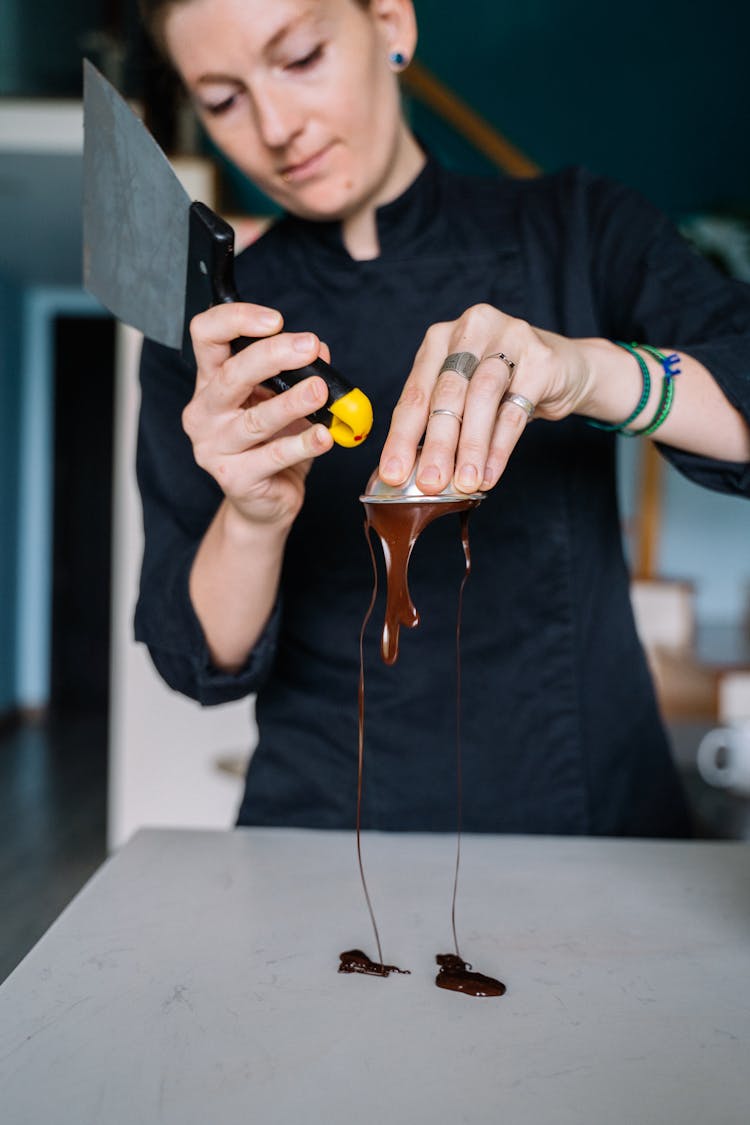 Woman Holding A Cup And A Metal Tool