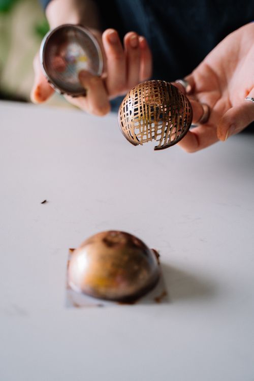 Free Close-up of a chef's hands creating intricate chocolate decoration for gourmet dessert. Stock Photo