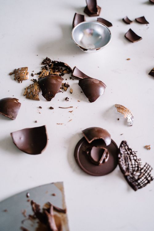 Free Close-up of broken chocolate pieces on white surface, showcasing a creative dessert arrangement. Stock Photo