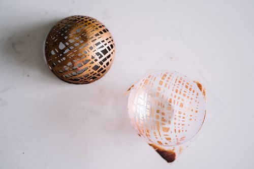 Free Close-up of decorative chocolate sphere showcasing intricate design on marble. Stock Photo