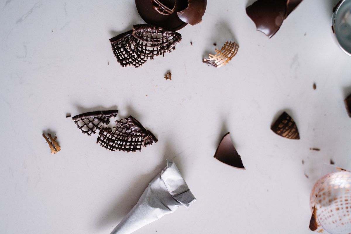 Creative arrangement of broken chocolate pieces on a marble surface. Perfect for food lovers.