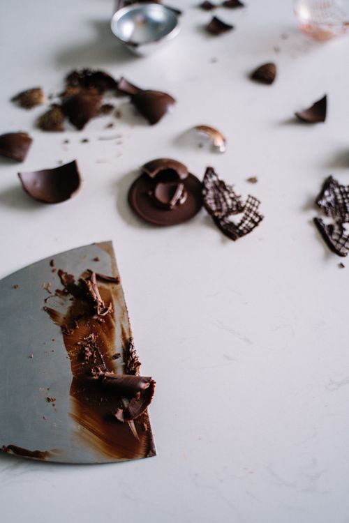 Free Artistic close-up of scattered chocolate pieces on a marble surface, perfect for food styling. Stock Photo