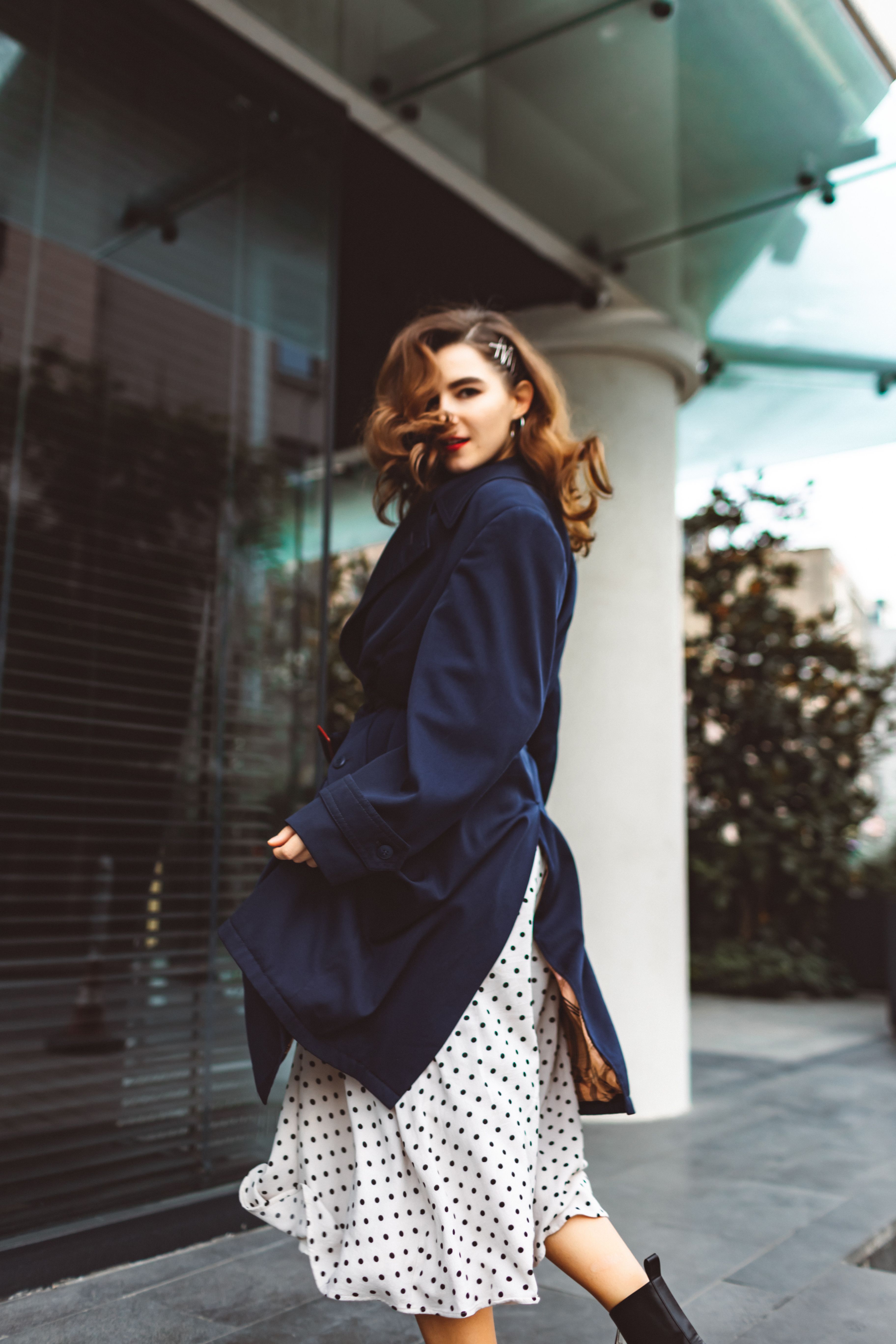 Woman in navy wool coat with satin skirt