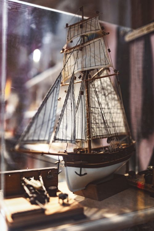 Free Close-up of a detailed model ship in a glass display, highlighting craftsmanship. Stock Photo
