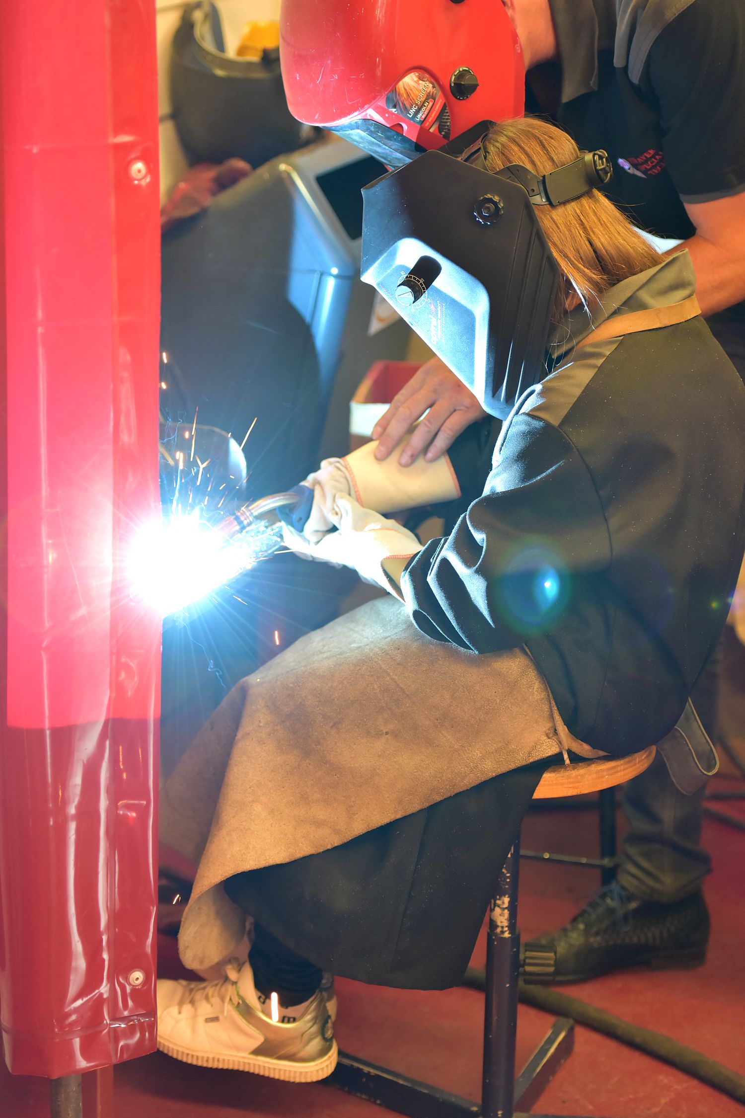 Student welding in workshop