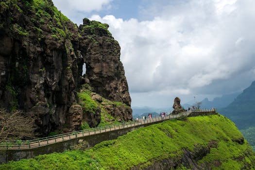 Tourists enjoy the stunning natural landscape of Malshej Ghat in Maharashtra, India, with its lush mountains and historic pathways.