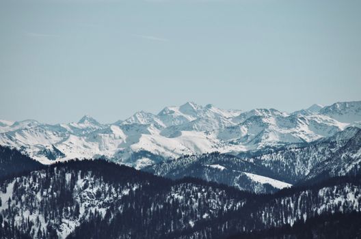 A breathtaking view of snow-capped mountains showcasing winter's serene beauty.