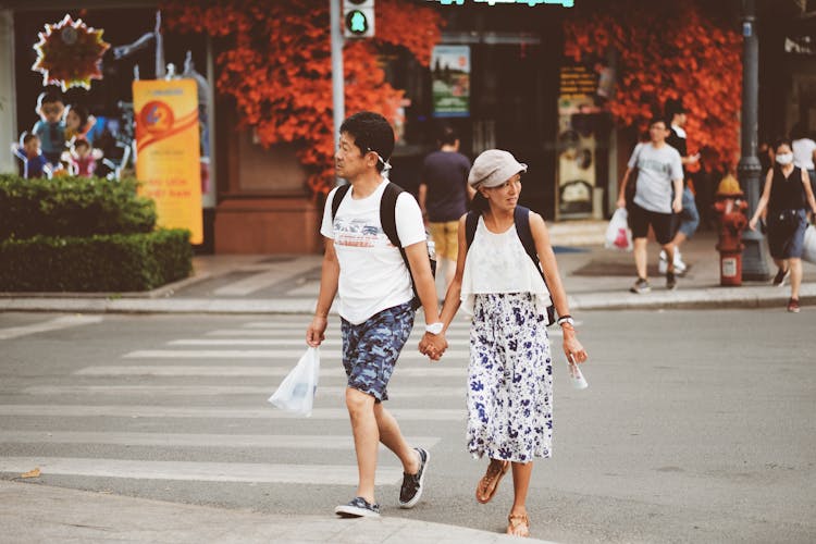 Couple Crossing The Street And Holding Hands 