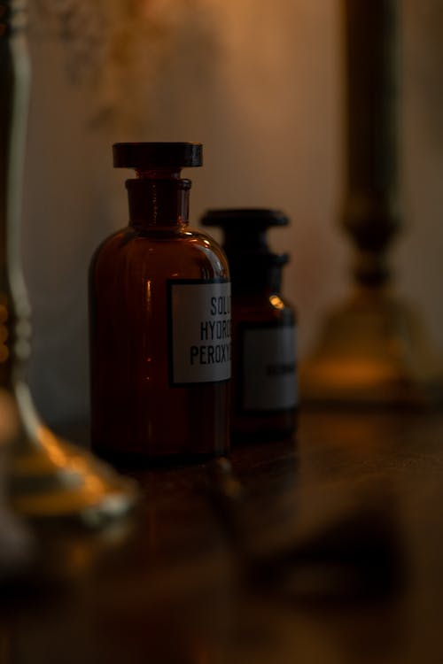 Close-up of Retro Bottles on Shelf in Dark
