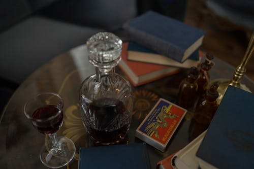 A Glass of Red Wine beside a Decanter