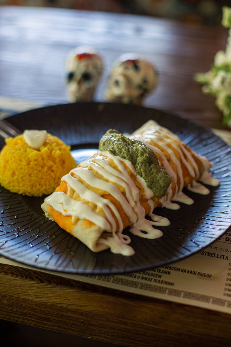 Tasty Mexican Dish With Cheese And Pesto Sauces And Saffron Rice