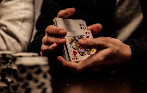 Person Holding Playing Cards