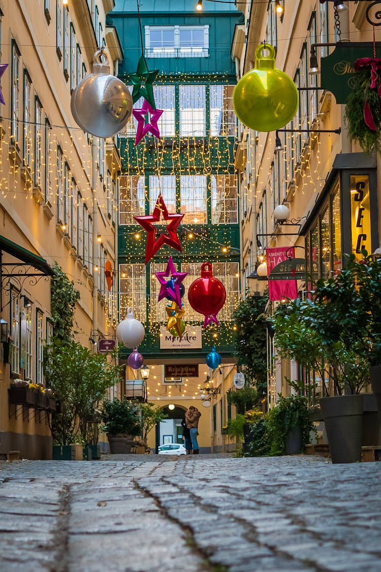 Walkway Between Building With Hanging Christmas Lights