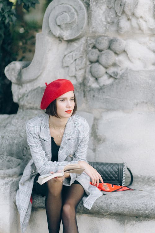 Woman in Plaid Blazer Holding a Book