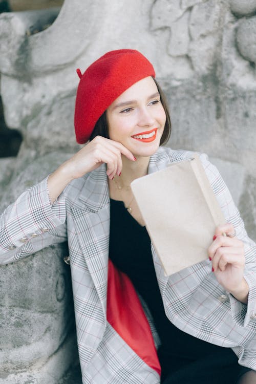Woman in Red Beret Hat Holding a Book