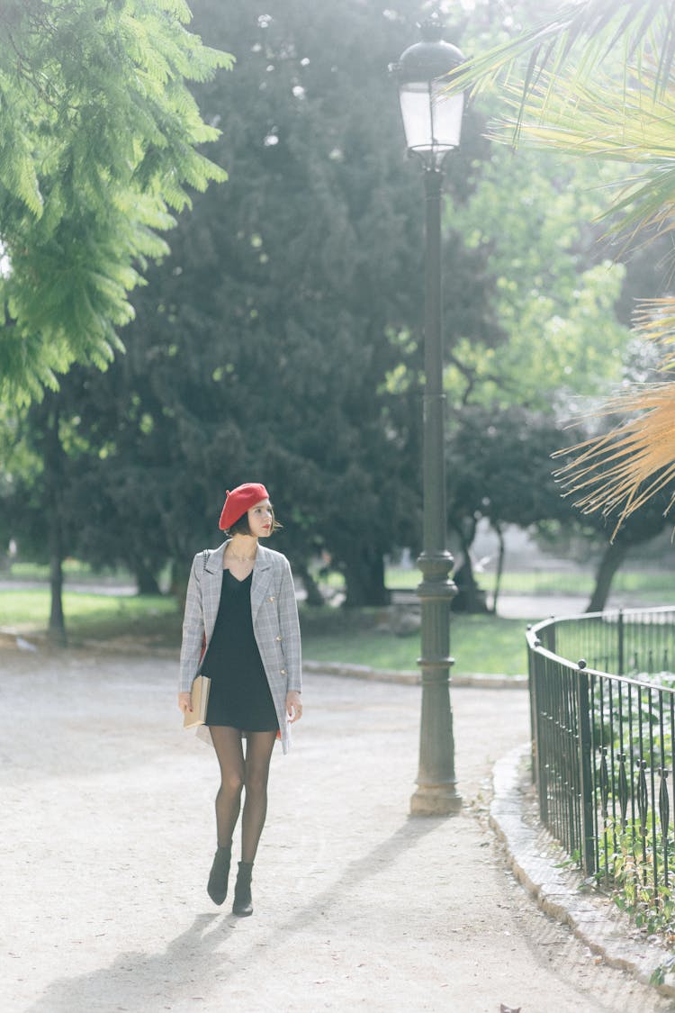 Woman In Plaid Blazer Walking In The Park