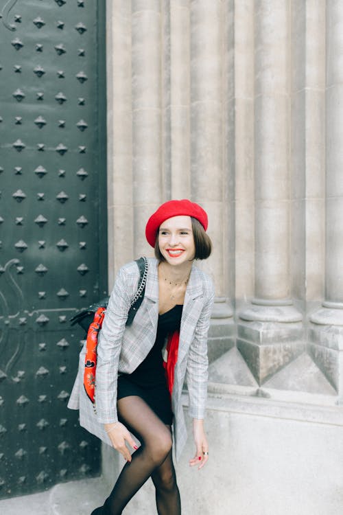 Woman Wearing a Blazer Waiting Beside a Wall