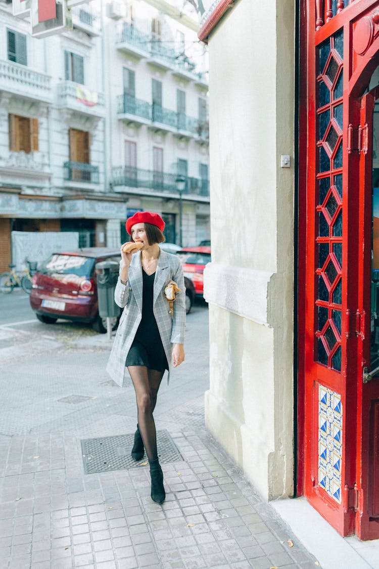 Woman Walking Beside A Building