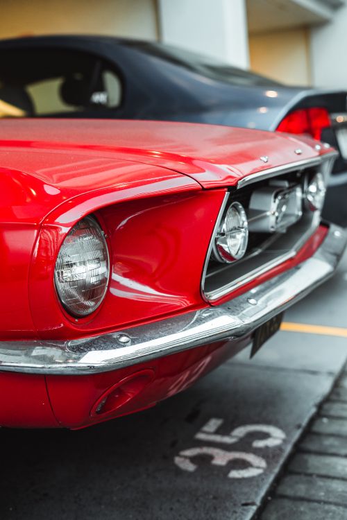 Free Front bumper of retro red car with round headlights parked on street in daytime Stock Photo