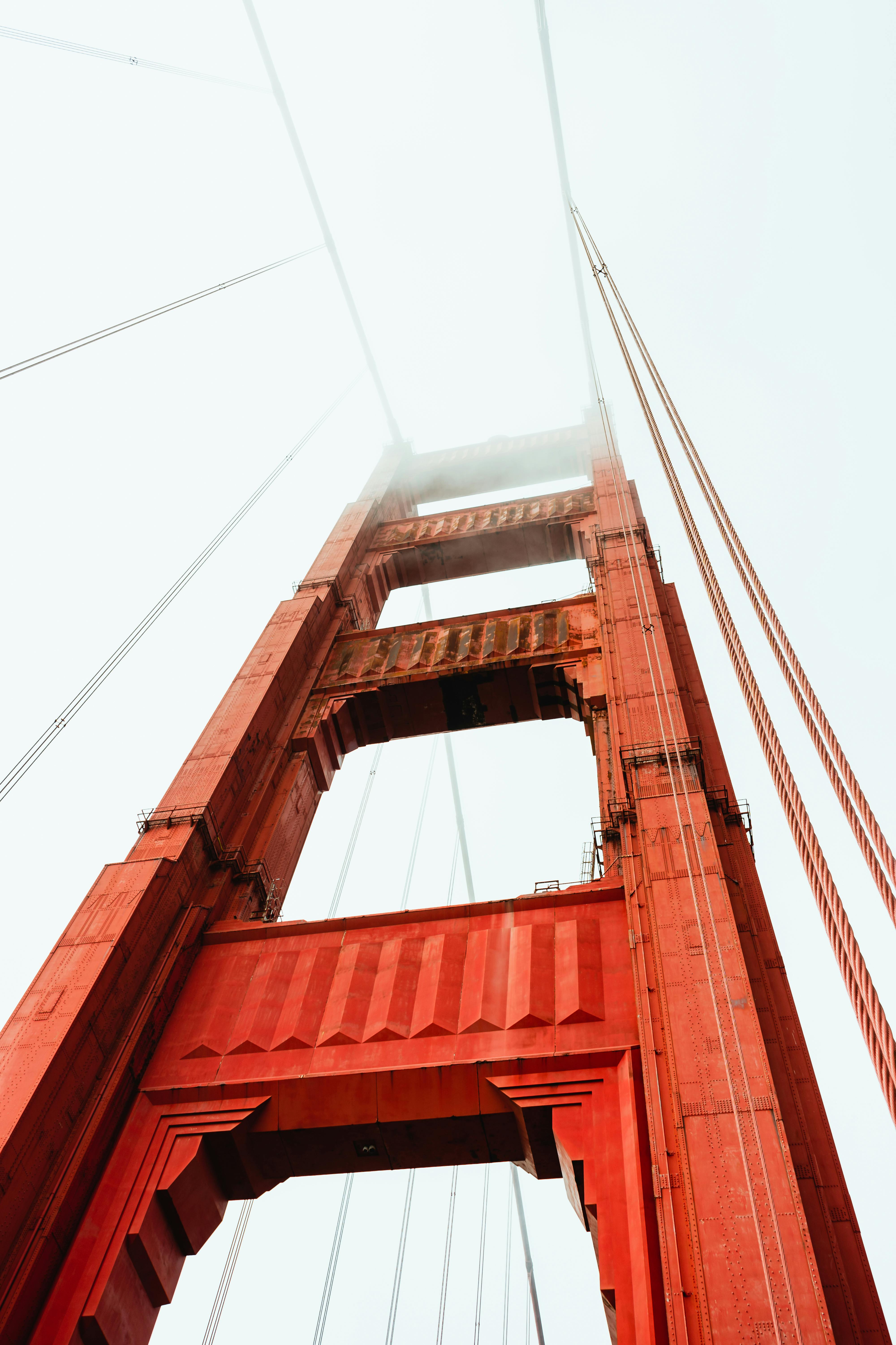 historic suspension bridge against cloudy sky