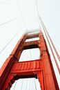 From below of famous red Golden Gate Bridge hidden under foggy sky in San Francisco