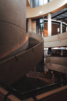 Elegant modern spiral staircase in a contemporary urban building interior.