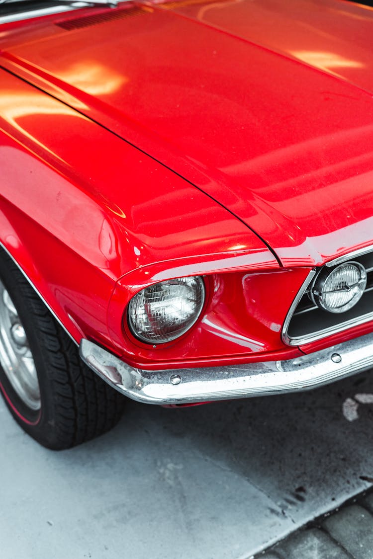 Shiny Red Retro Car Parked On Street In Sunlight