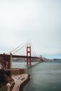 Historic suspension bridge hidden under thick fog in city