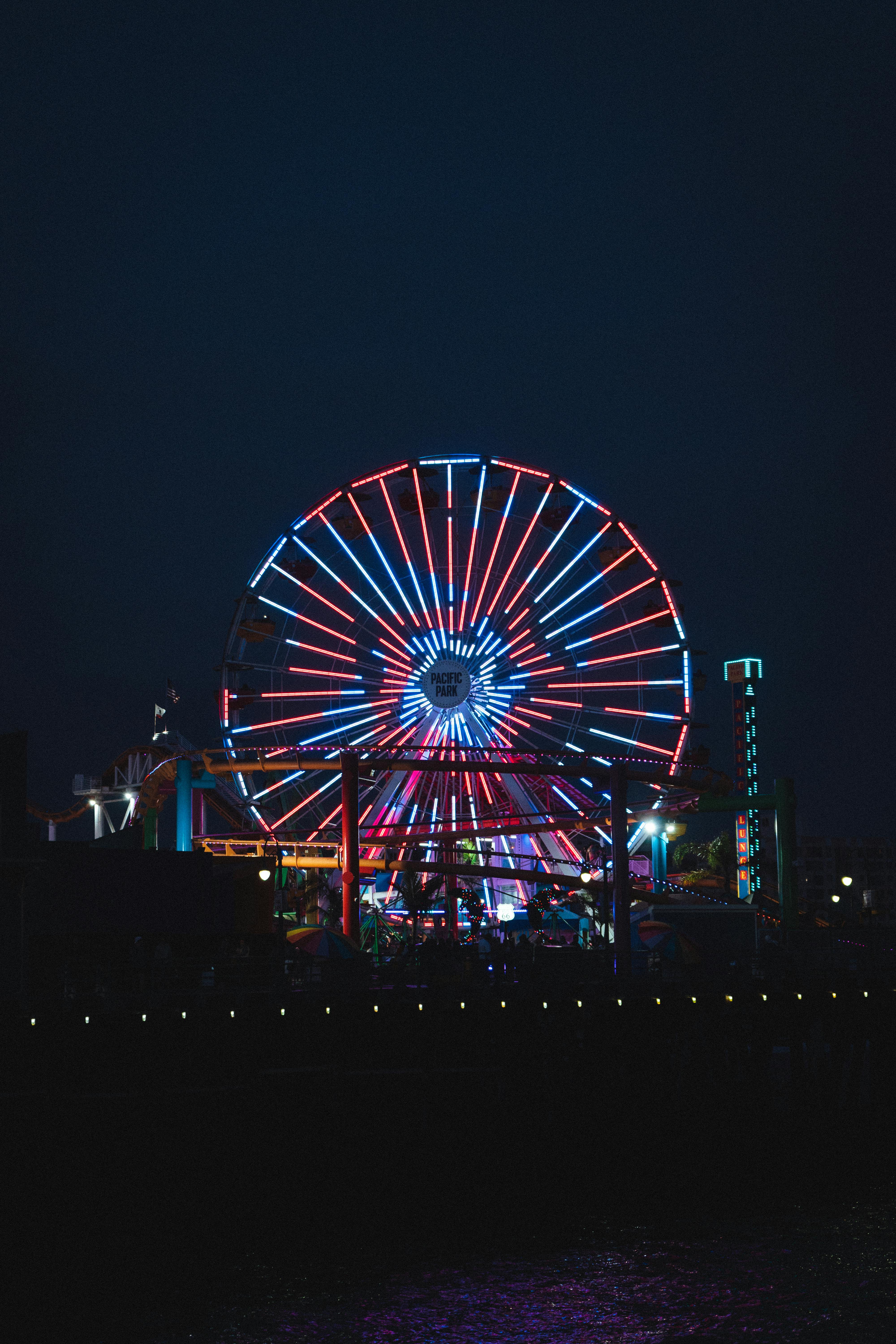 illuminated ferris wheel in amusement park at night