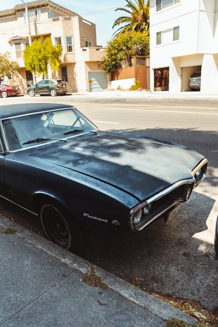 Retro Automobile Parked Near Sidewalk In City Suburb