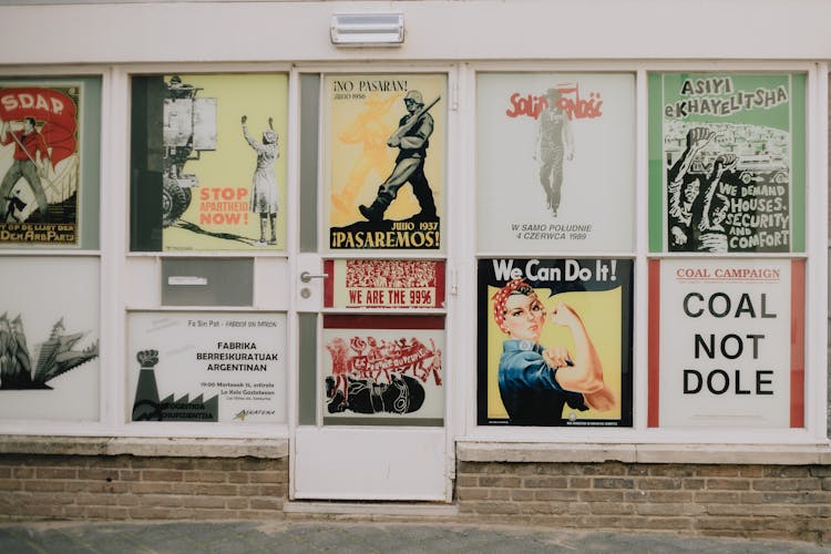 A Variety Of Posters On A Storefront