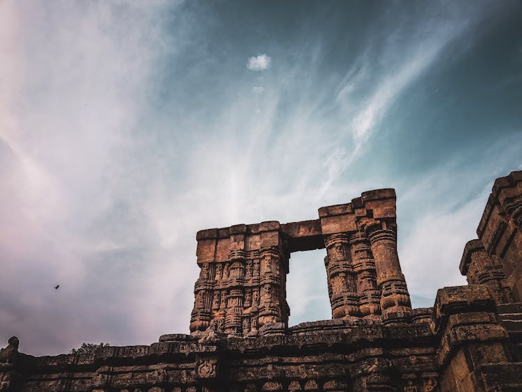 Architectural Details Of Old Hindu Temple Under Cloudy Sky