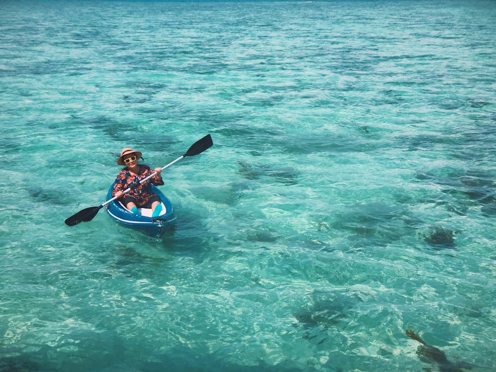 Free Man Paddling on a Kayak  Stock Photo