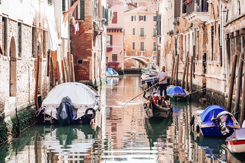 Boats on Water Between Buildings