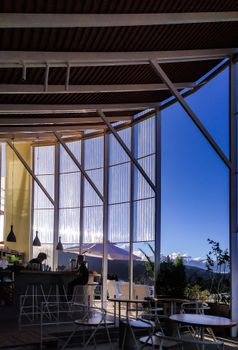 Bright modern café interior with open windows and scenic mountain views in Đà Lạt, Vietnam.