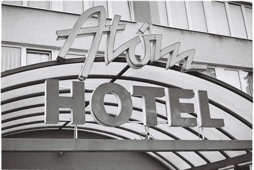 Grayscale Photo of Atom Hotel Signage