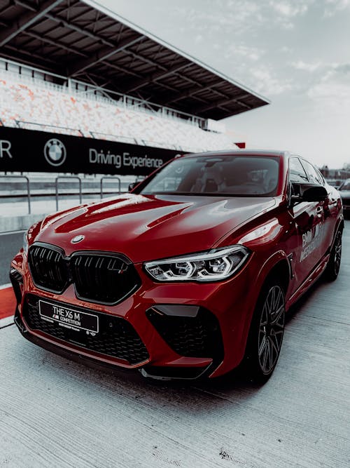 Red BMW Sedan on Parked on Concrete Surface